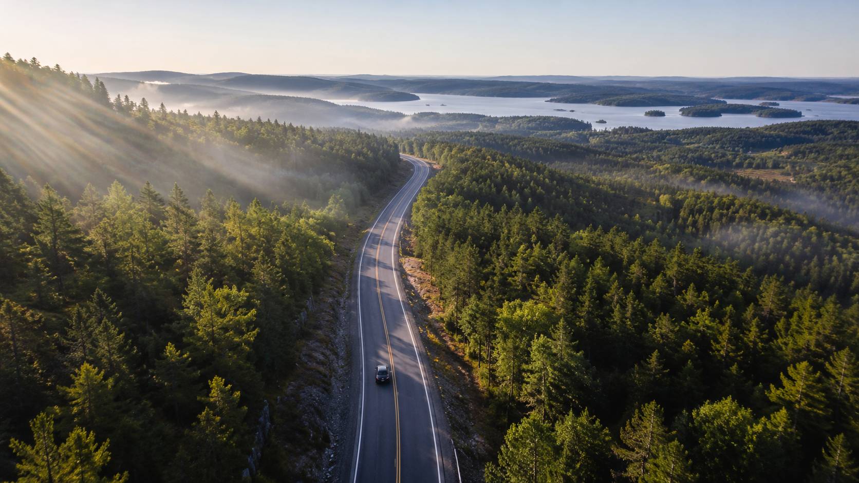 Road winding north through pine forest toward Muskoka lakes